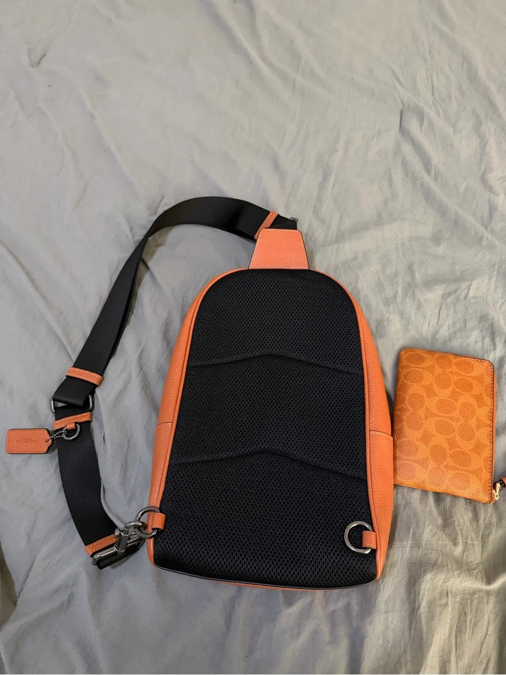 Coach Orange Leather Sling Bag with Black Strap and wristlet new without tags
